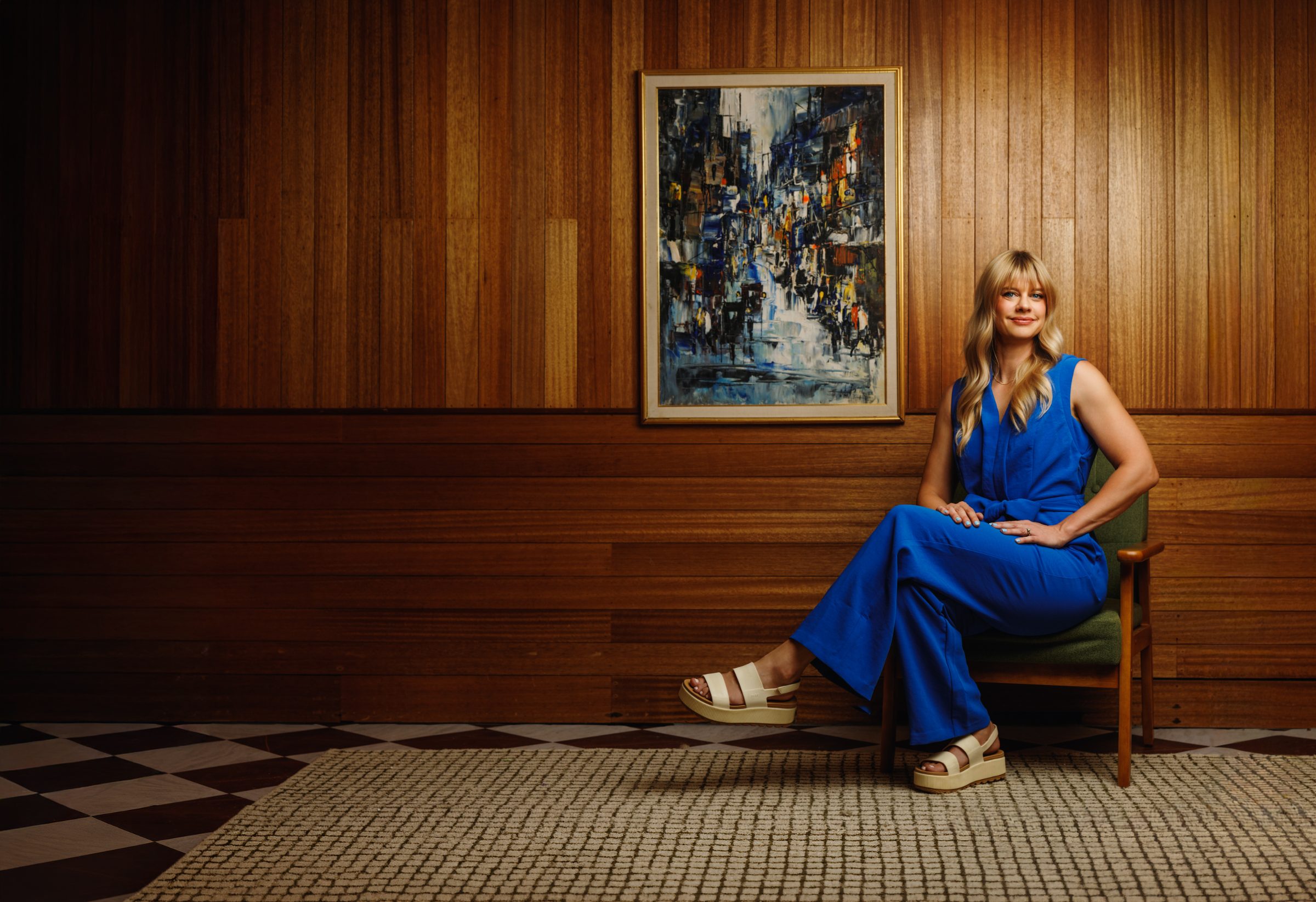 Jodi Anne Roberts, founder of Customer Research Labs, seated in a wood-paneled room
